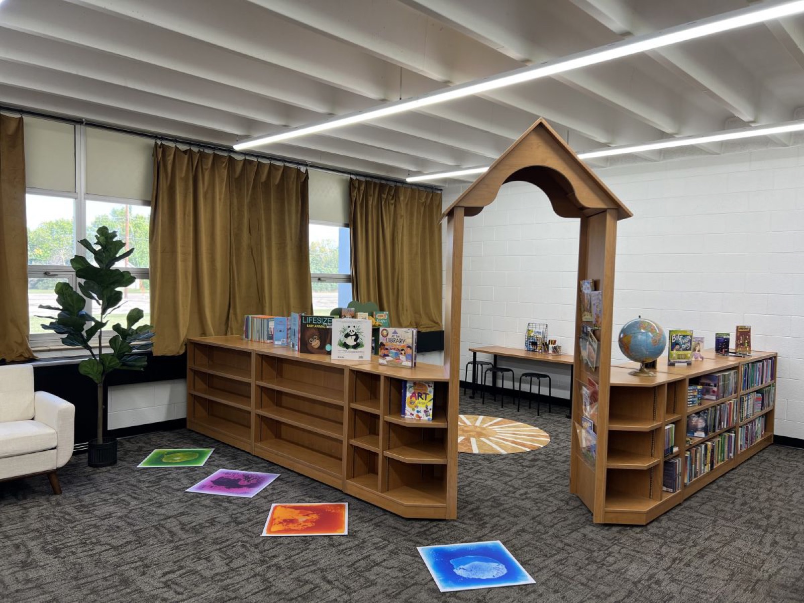 Bookshelves and a wooden reading arch at the Halliday Public Library