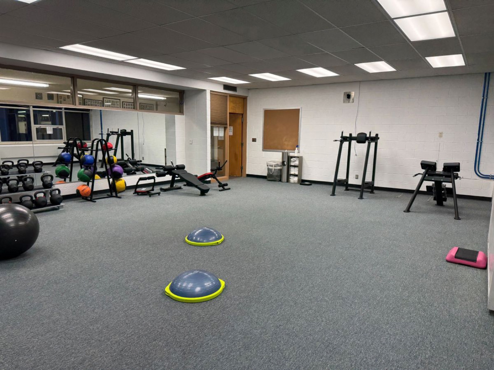 Kettlebells, medicine balls and a mirrored wall in the Wolverine Den fitness center