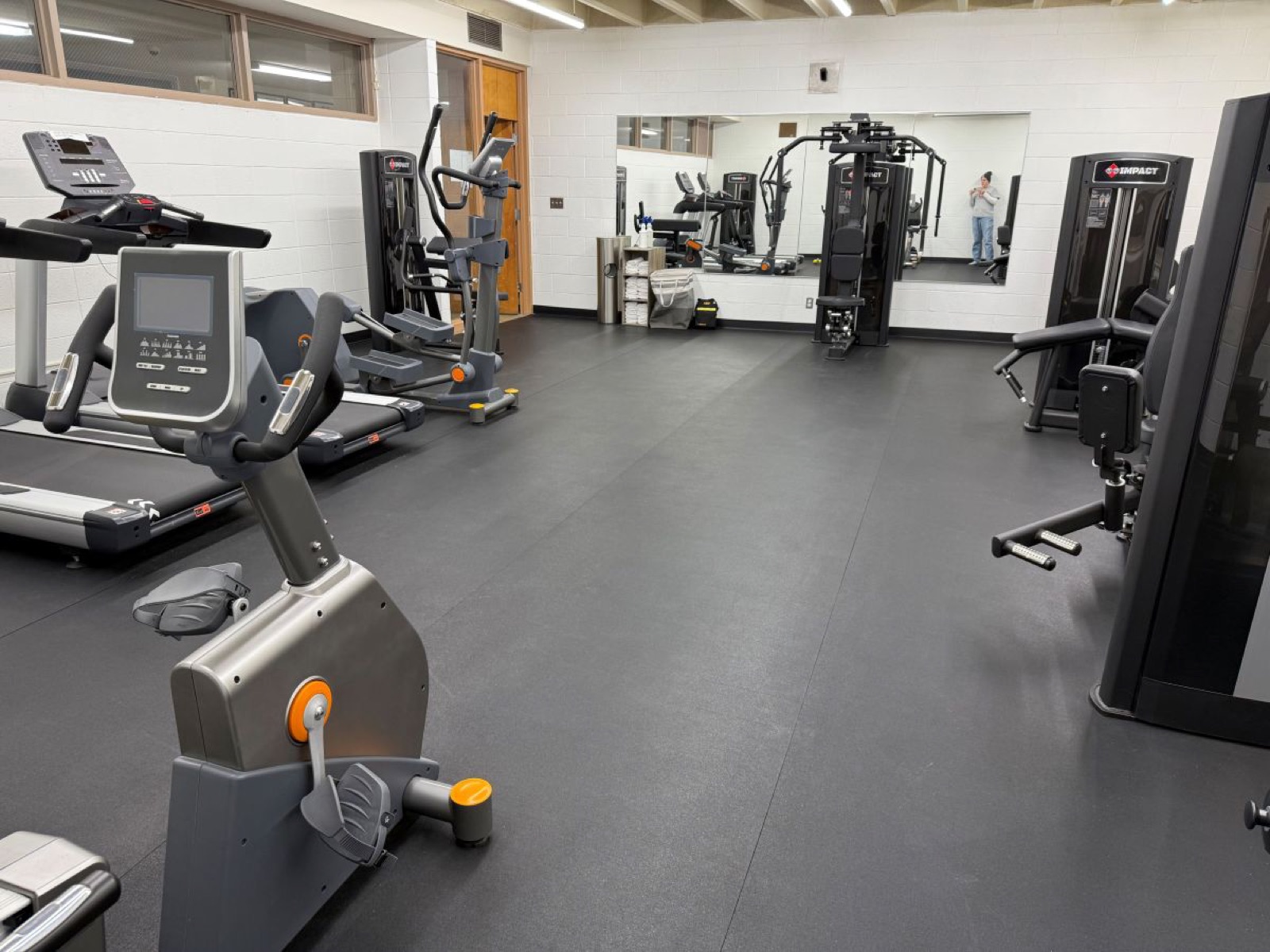 Treadmills, an exercise bike and cable machines in the Wolverine Den fitness center