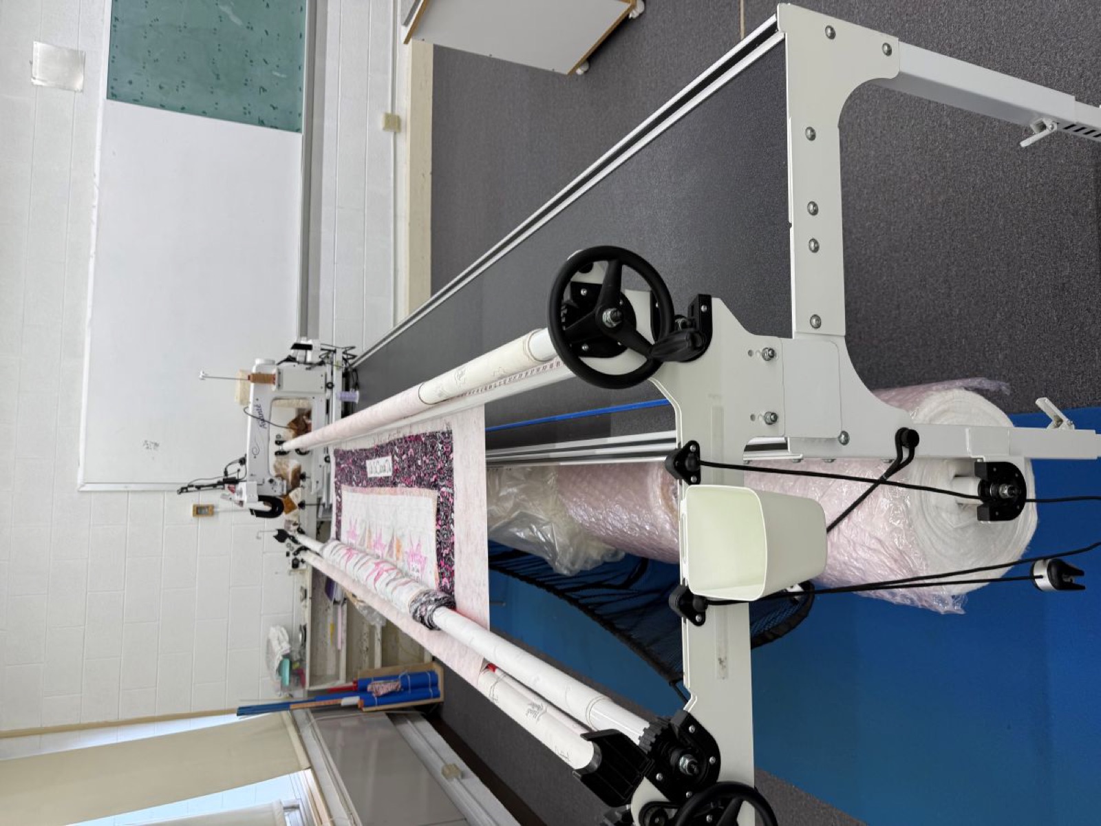 Long-arm quilting frame with a quilt in progress